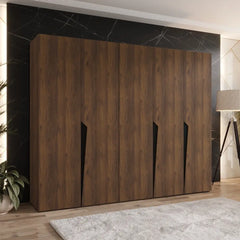 The hinged wardrobe in a dark wood grain finish positioned in a modern room setting