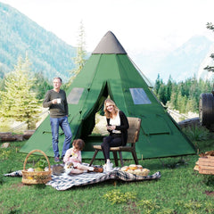 A family enjoying a picnic outside a green tipi tent in a natural setting