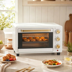 HOMCOM 21L Mini Countertop Oven, the small kitchen appliance on a kitchen counter with croissants and chicken legs