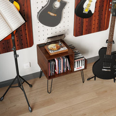 The turntable stand placed in a music room next to guitars and a music stand