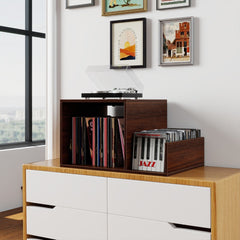 The turntable stand sitting on top of a white chest of drawers against a wall