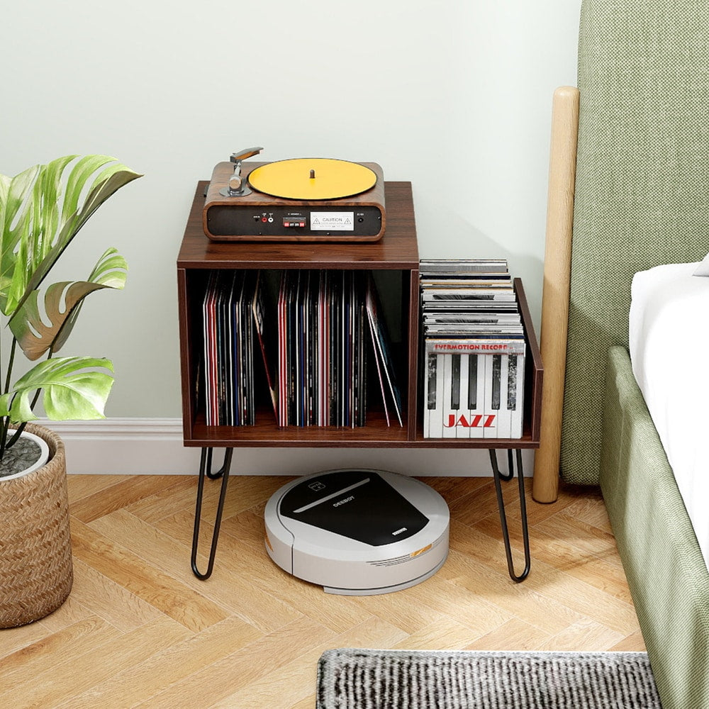 The turntable stand in a bedroom with a robot vacuum cleaner underneath it