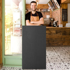 A black lectern stand with wood grain texture standing in a shop doorway