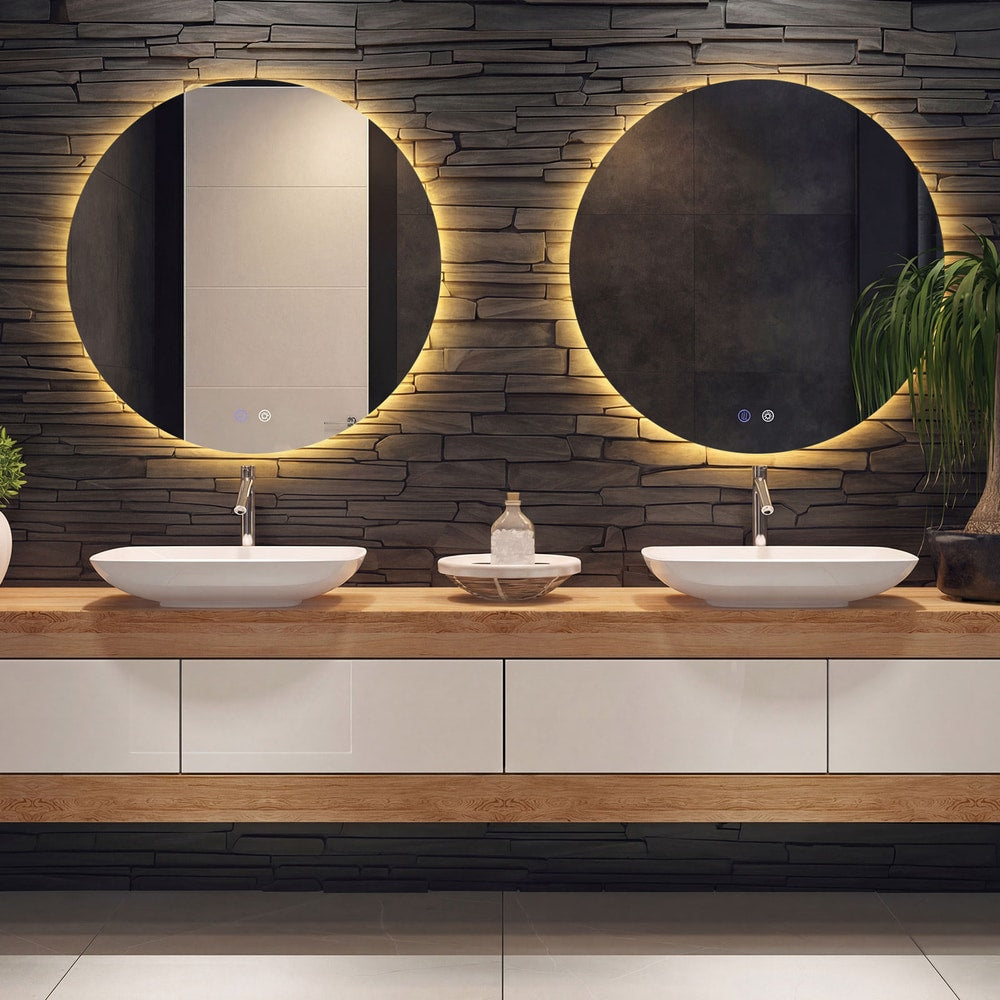 Two round LED lighted mirrors are mounted above double sinks and a wooden vanity