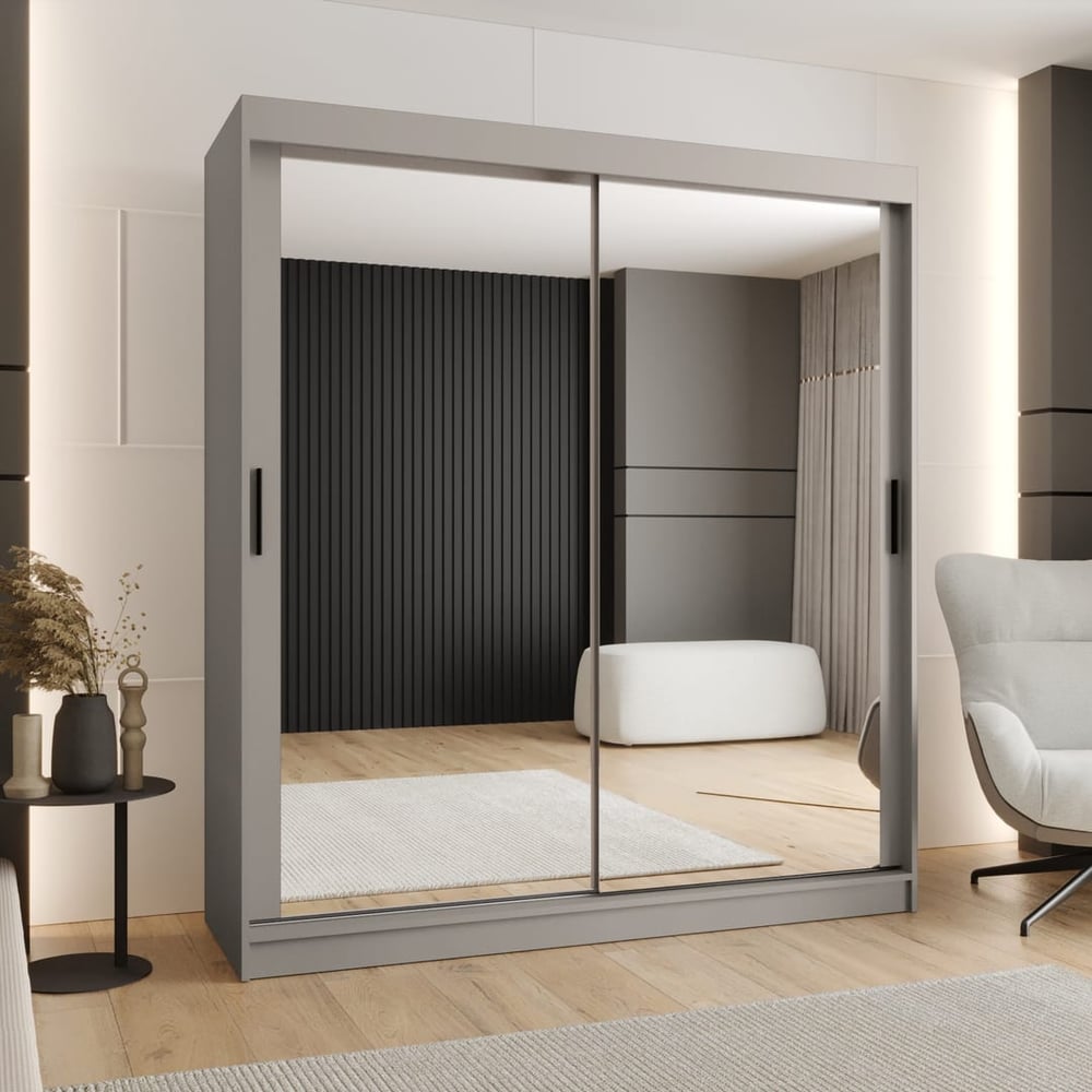 The sliding door wardrobe in grey with mirrored doors reflecting a bedroom setting