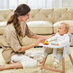 The low wooden high chair with a white tray and beige seat cushion