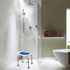Shower stool in use in a tiled shower cubicle with water spraying