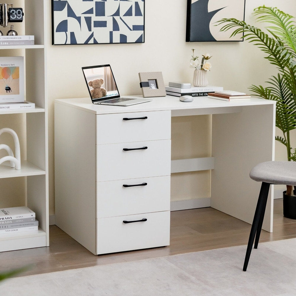 The office desk is shown in a room with a laptop, books and plants on it