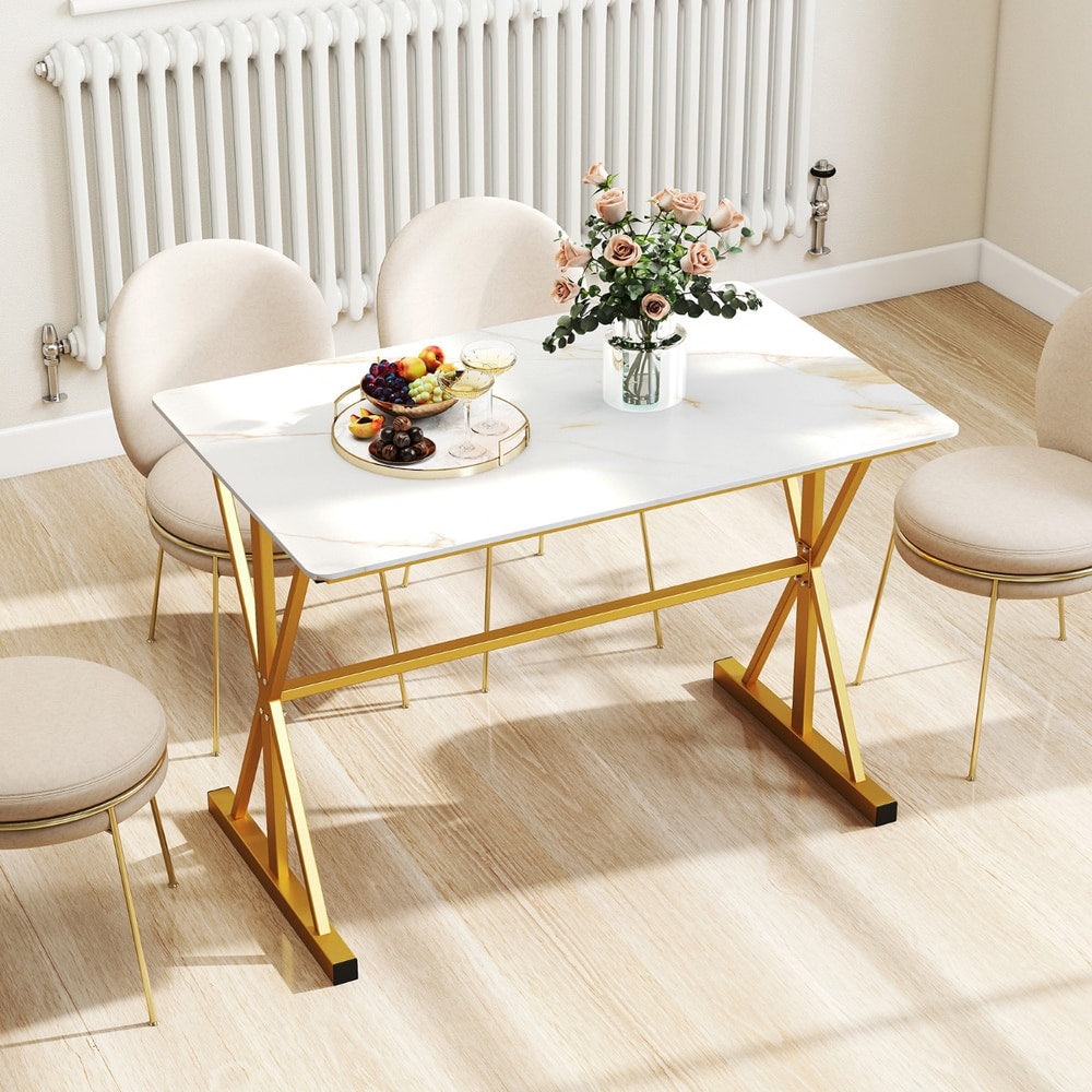 The dining table styled with a fruit platter and flowers in a room with light wooden flooring