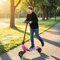 A happy boy riding the pink electric scooter for kids outdoors on a sunny day