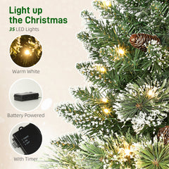 HOMCOM 60 cm Prelit Small Christmas Tree, Snow Flocked Tabletop Mini Xmas Tree with 35 LED Lights, Pine Cones and Linen Cover Base, Battery Operated, Green