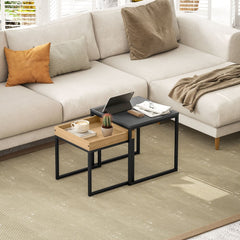 The nesting coffee tables are placed in a lounge area with a laptop and tablet