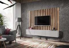 The entertainment unit in a modern living room with a grey sofa and a patterned rug