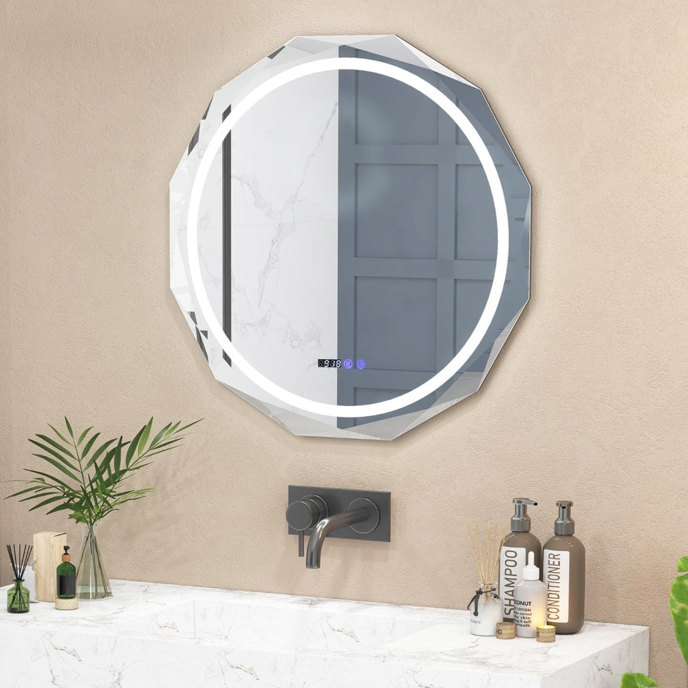 The illuminated bathroom mirror mounted above a marble vanity unit with toiletries and a tap