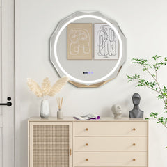 The decorative wall mirror hanging above a wooden chest of drawers in a bright living space