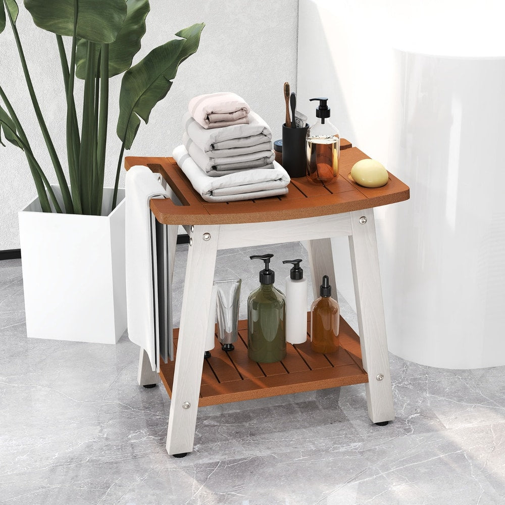 The shower stool holding folded towels and bathroom accessories next to a large plant
