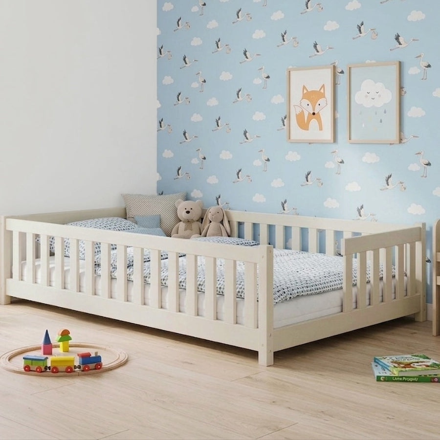 Wooden Single Bed Ivy in a nursery with blue cloud wallpaper and a wooden toy train on the floor