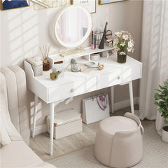 The office desk styled as a vanity table in a bedroom with a mirror and stool