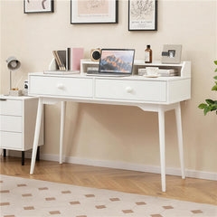 The office desk placed in a bright home office setting with wall art above it