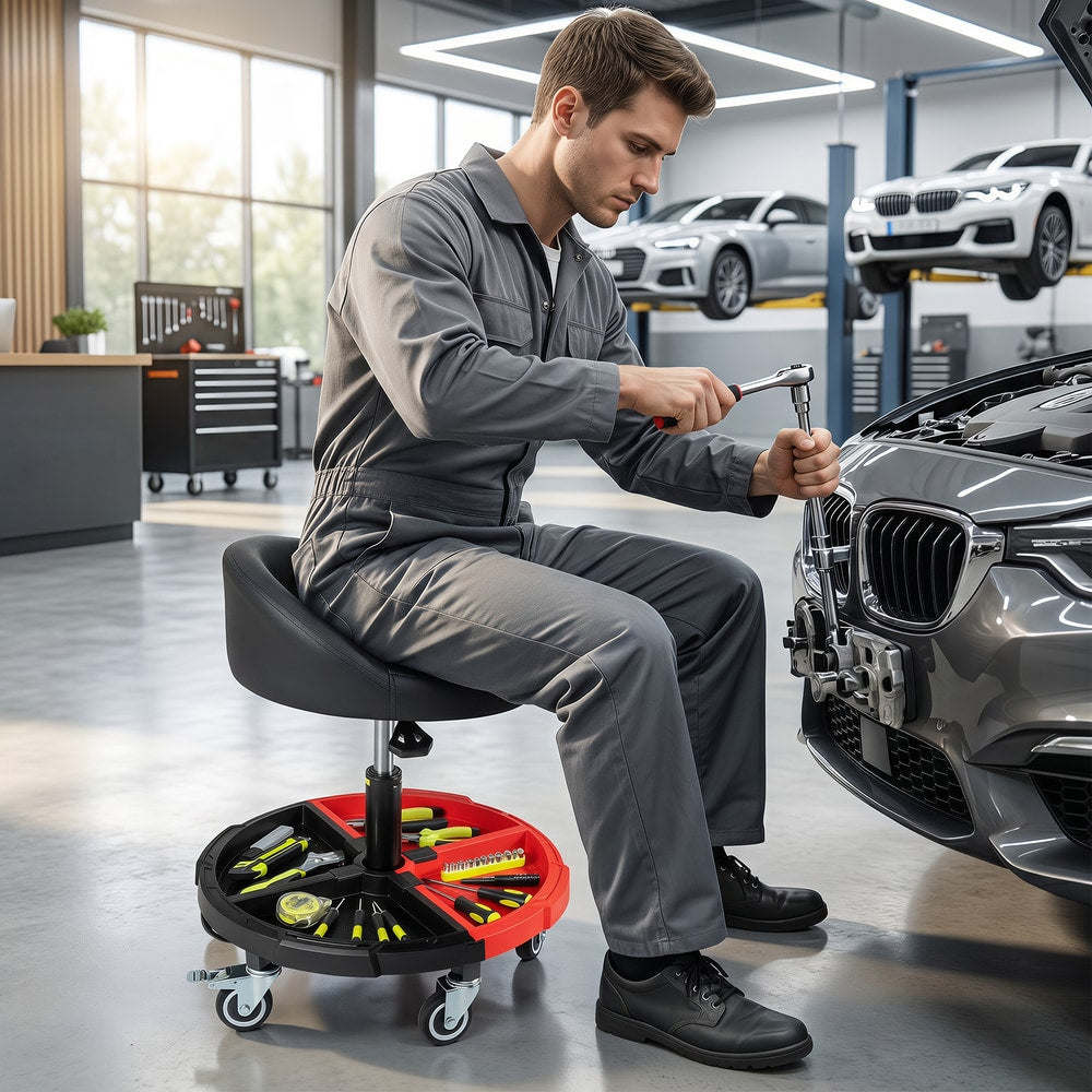 Mechanic using the red rolling stool with tool tray to work on a car