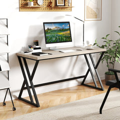 The grey computer desk set up in a home office with a computer and accessories