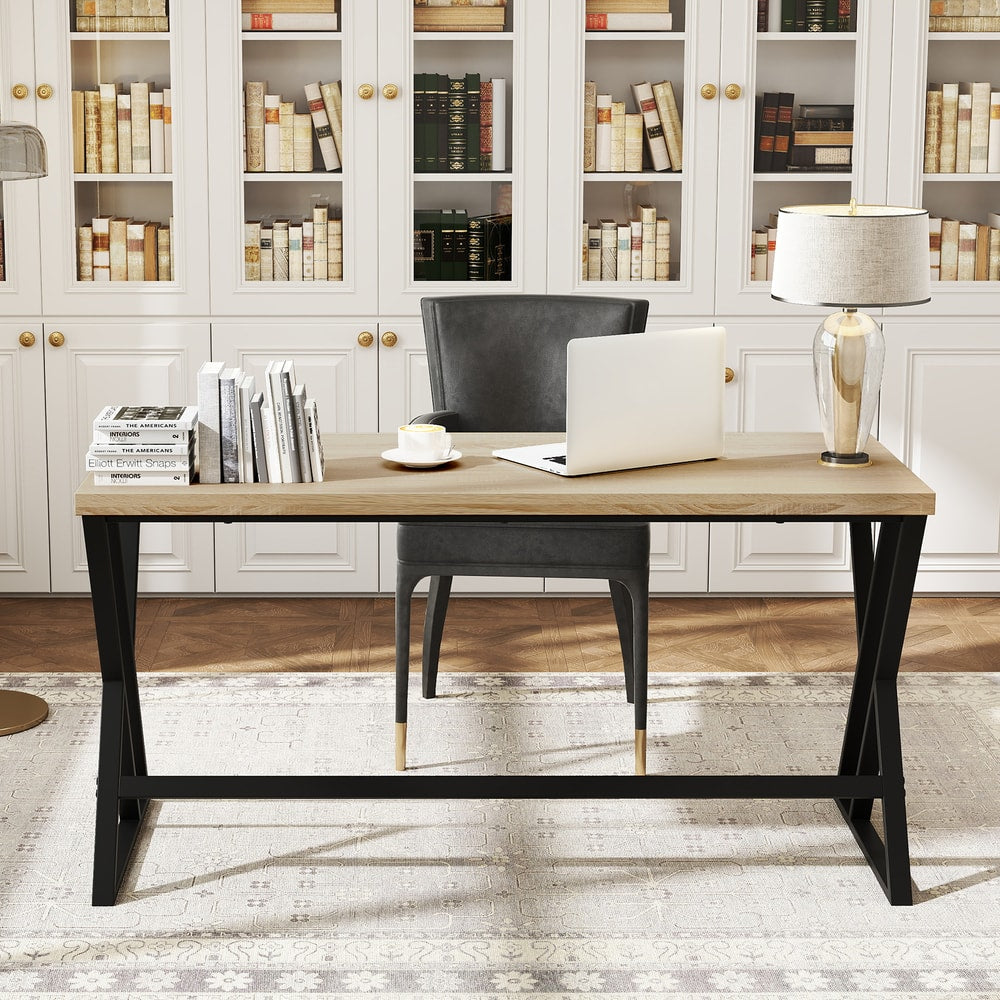 The grey office desk with a laptop and books in a study room