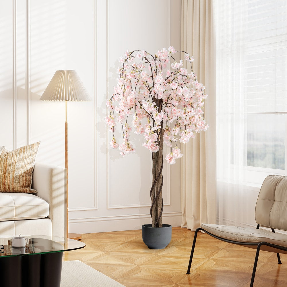 Artificial cherry blossom tree in a grey pot in a living room setting