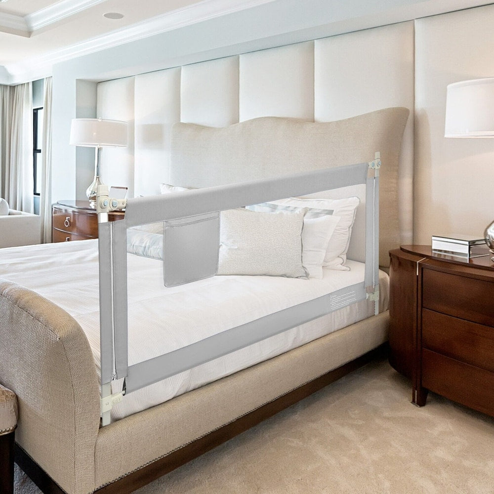 The grey bed guardrail installed on a bed with white bedding and pillows