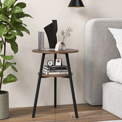 The side table placed next to a bed with books and decor on the shelves