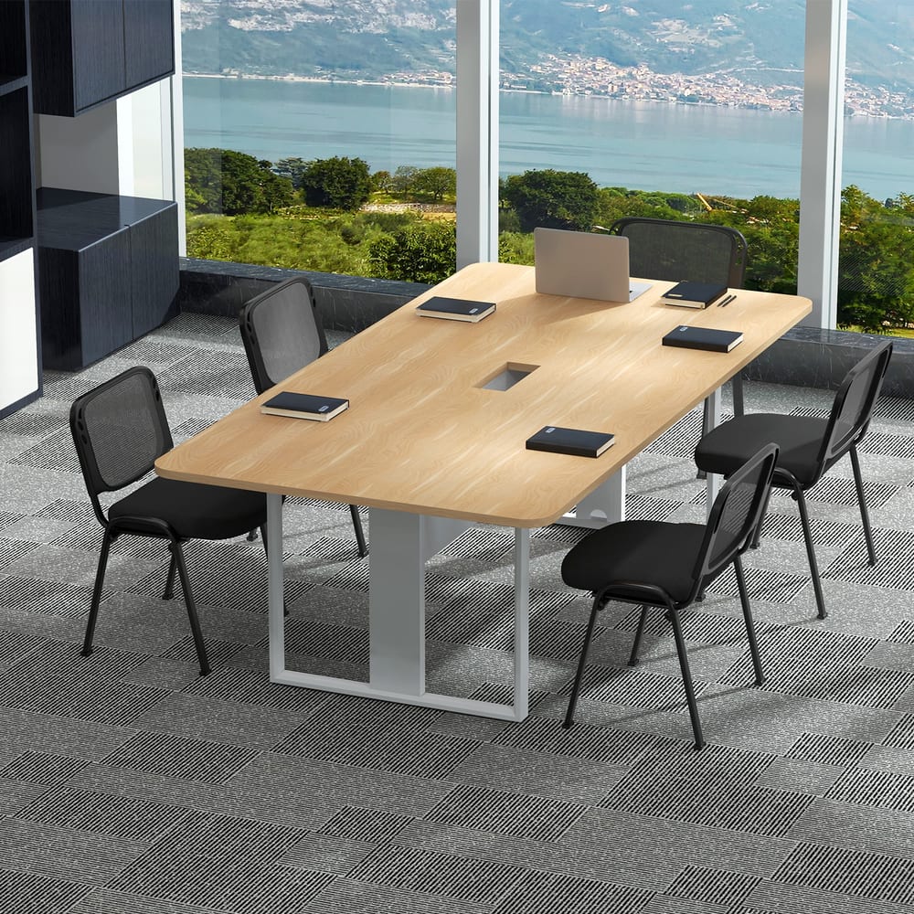 Black office chairs around a light wood meeting table