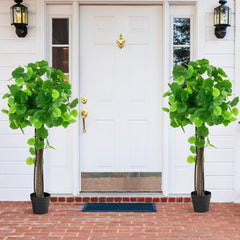 Two artificial crabapple trees in pots flanking a white front door on a brick path