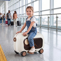 A young girl rides on the brown kids luggage in an airport terminal