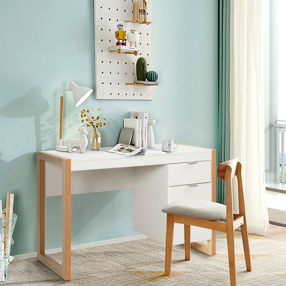A white wooden desk with drawers and a cabinet in a bright room