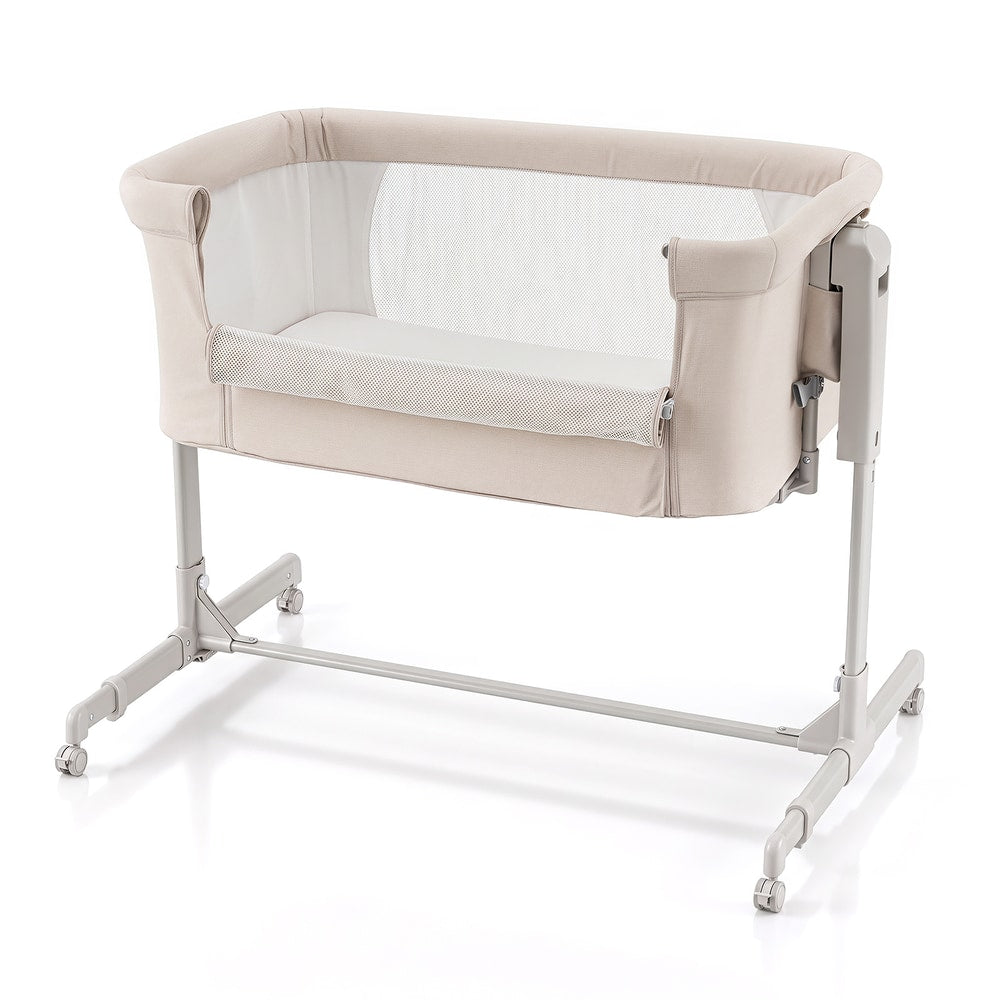 Beige bedside sleeper with mesh sides and a mattress