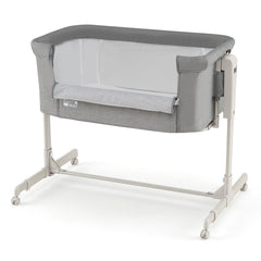 Grey bassinet and bedside sleeper with white frame and castors