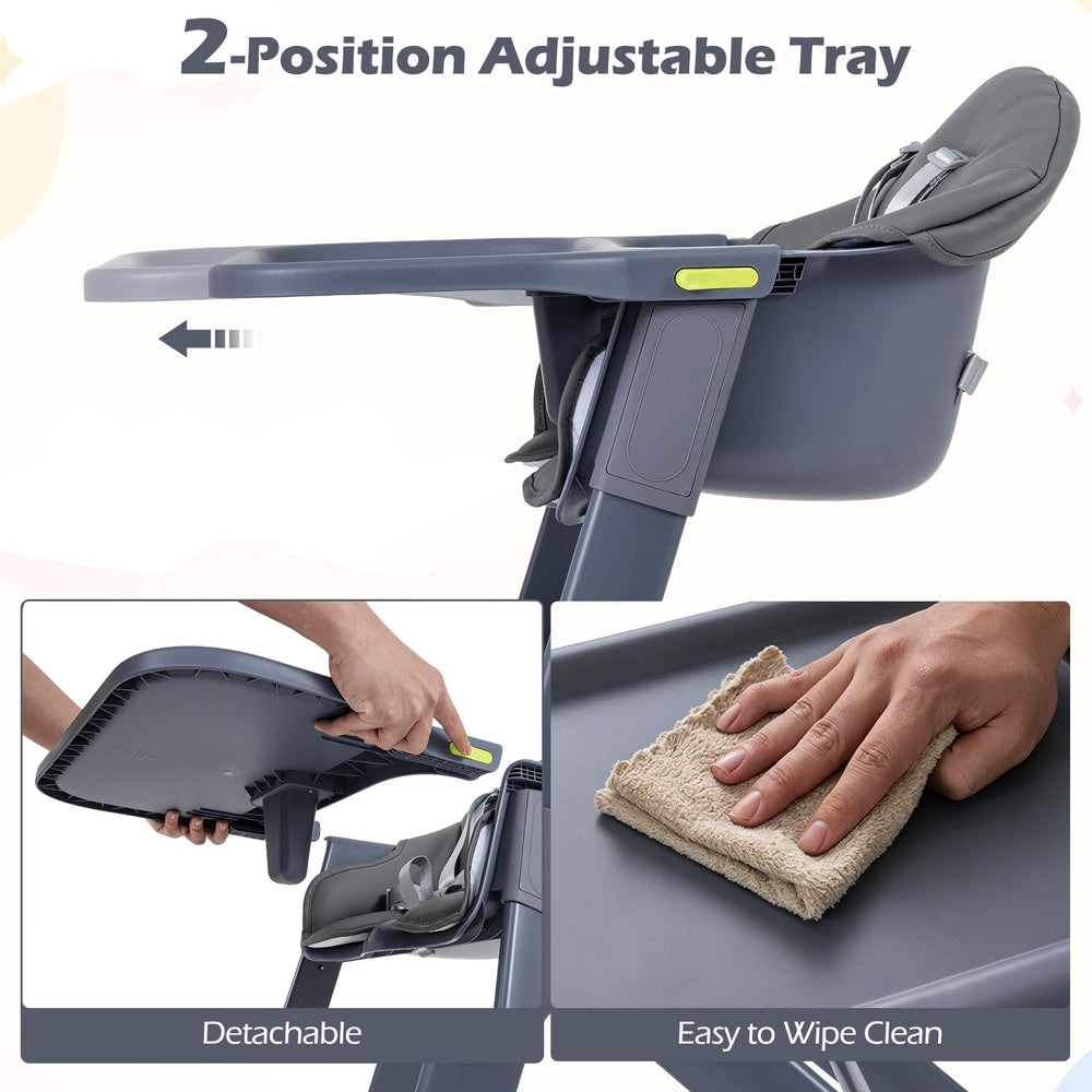 The high chair tray being adjusted and wiped clean by a hand with a cloth