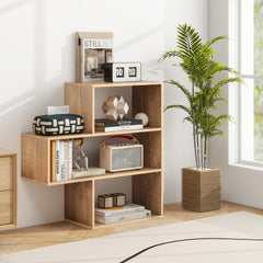 The irregular open back bookcase is placed against a wall next to a large potted plant