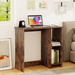 The small home office desk is positioned next to a bed in a bedroom setting