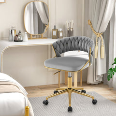Grey office chair with gold legs next to a bed