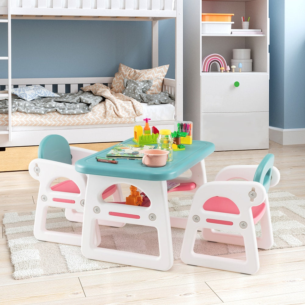 The kids table and chair set placed in a child's bedroom with toys on the tabletop