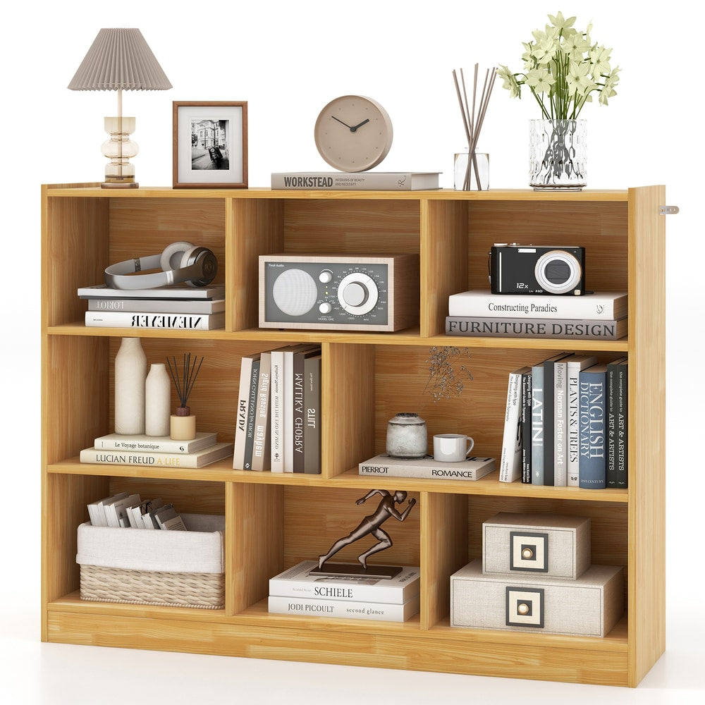 Close-up of the yellow wooden bookcase showing the compartments and some items
