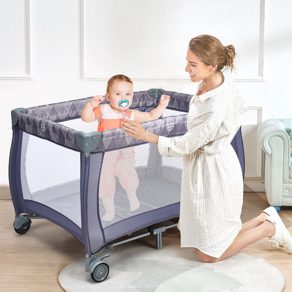 3 in 1 Convertible Bassinet Cot, the baby playpen in use with a mother playing with her child inside the mesh enclosure