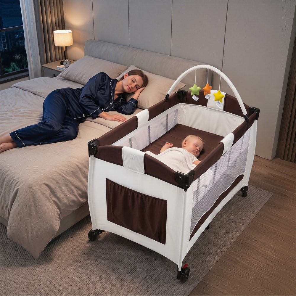 A baby sleeps soundly in the baby playpen next to a bed