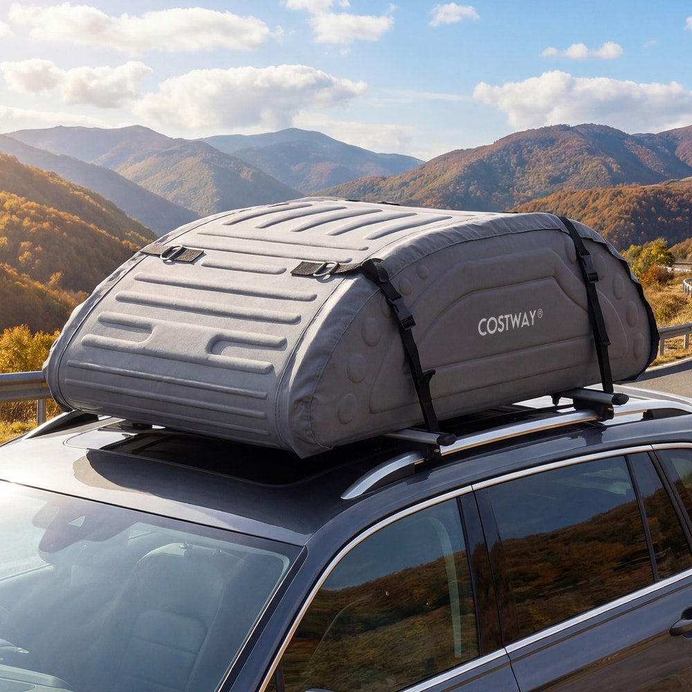 The grey waterproof car roof bag is secured to roof bars on a car