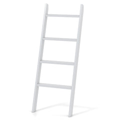 A white wooden blanket ladder leaning against a wall