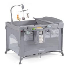 The grey infant bedside sleeper with a changing table and hanging toys