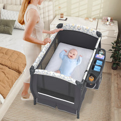 The bedside sleeper in a bedroom with a baby lying on the mattress while a parent watches