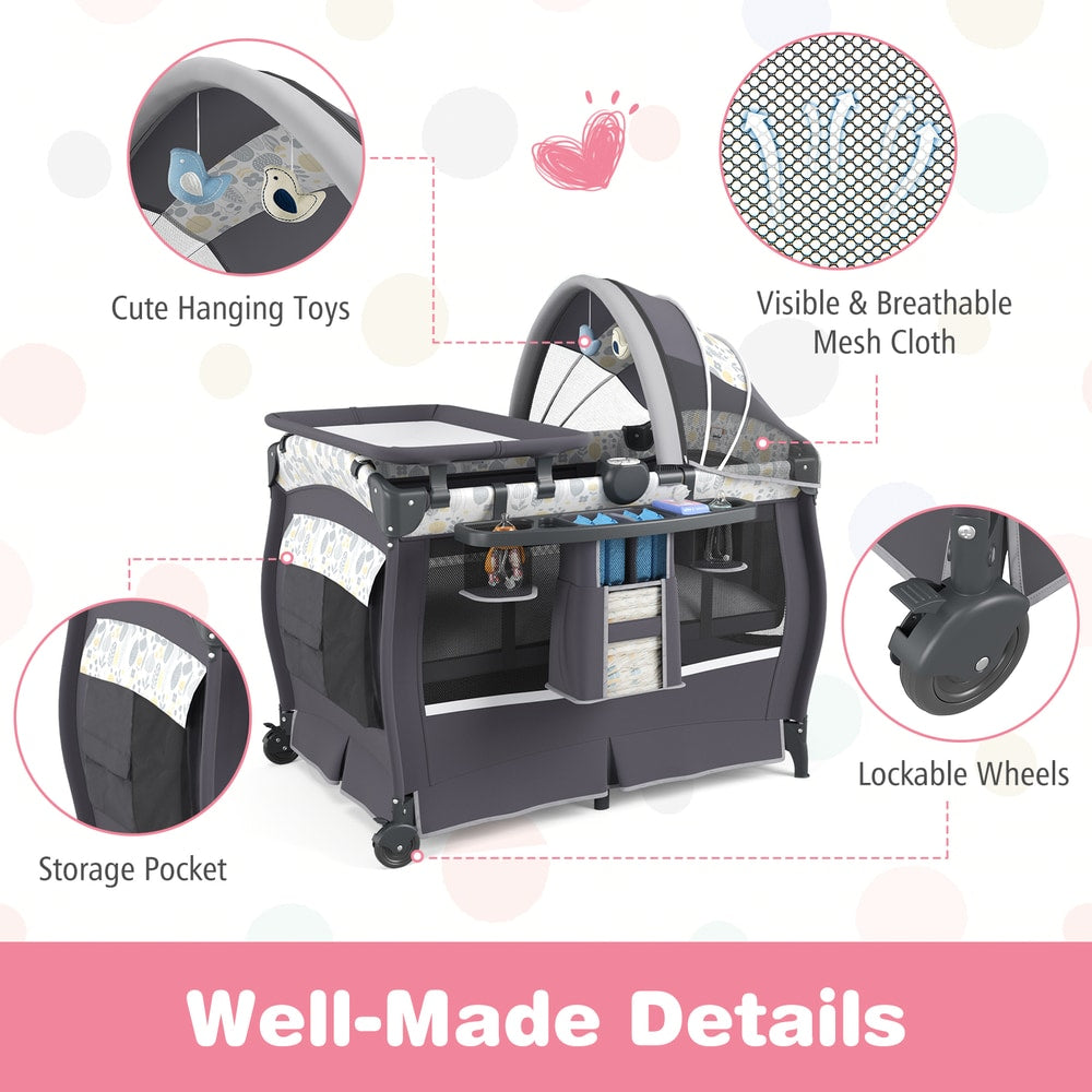 5 in 1 Portable Pack and Play, the nursery sleeper highlighting the hanging toys, mesh sides, storage pocket and wheels