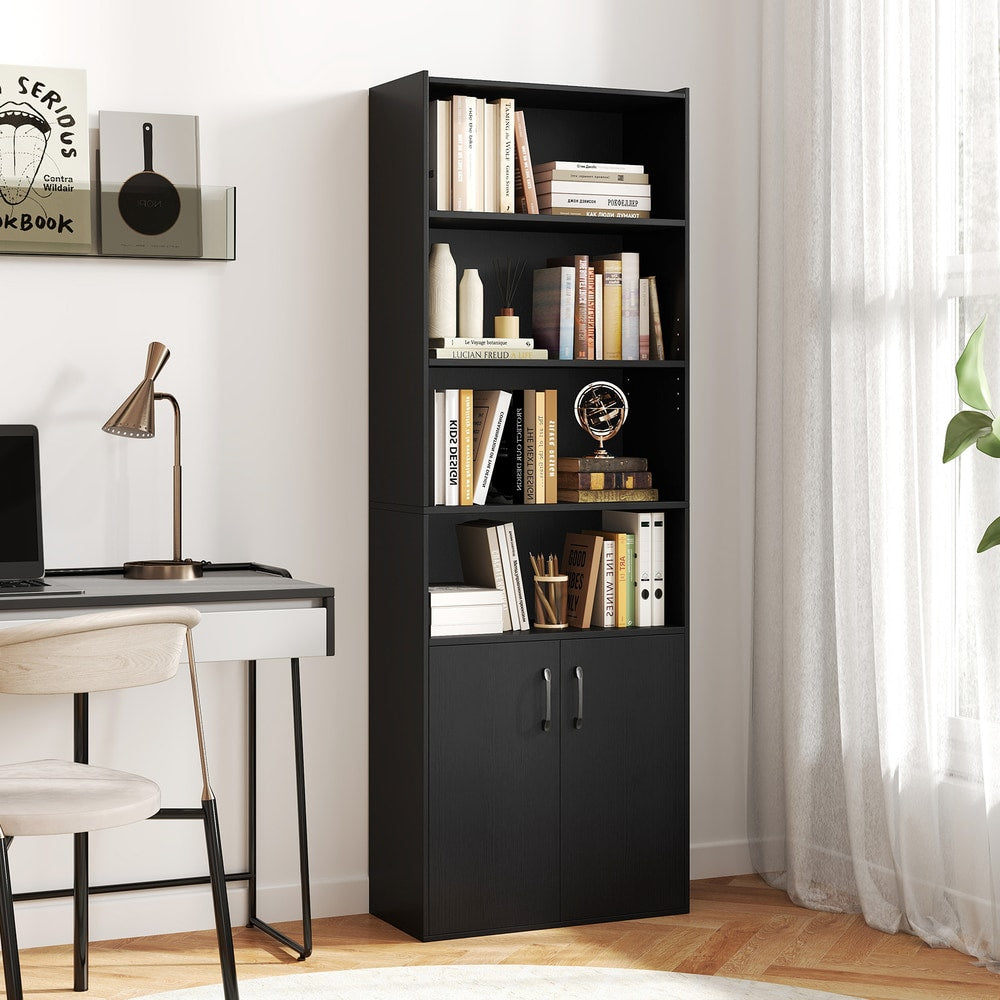 the black bookcase with books and decorative items on its shelves, placed next to a desk