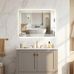 The bathroom mirror mounted above a vanity unit in a modern marble tiled room